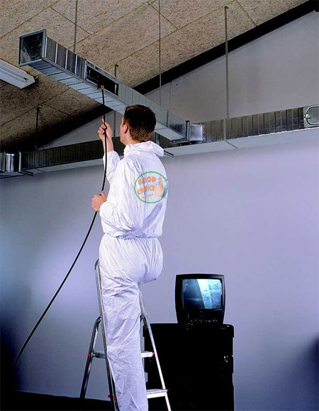 Technician inspecting duct